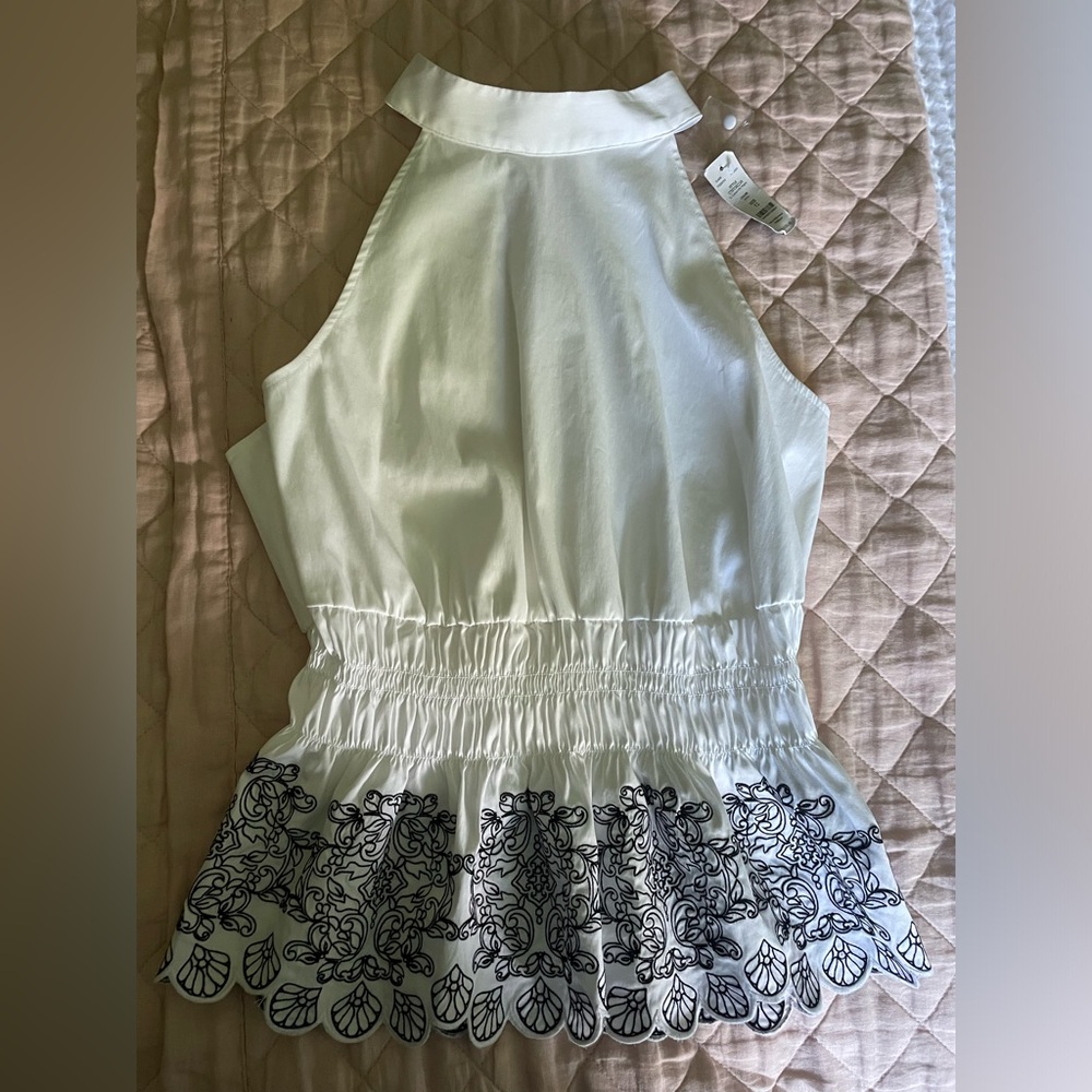 Cute top, partial open back  Can be woren dressy or casual.